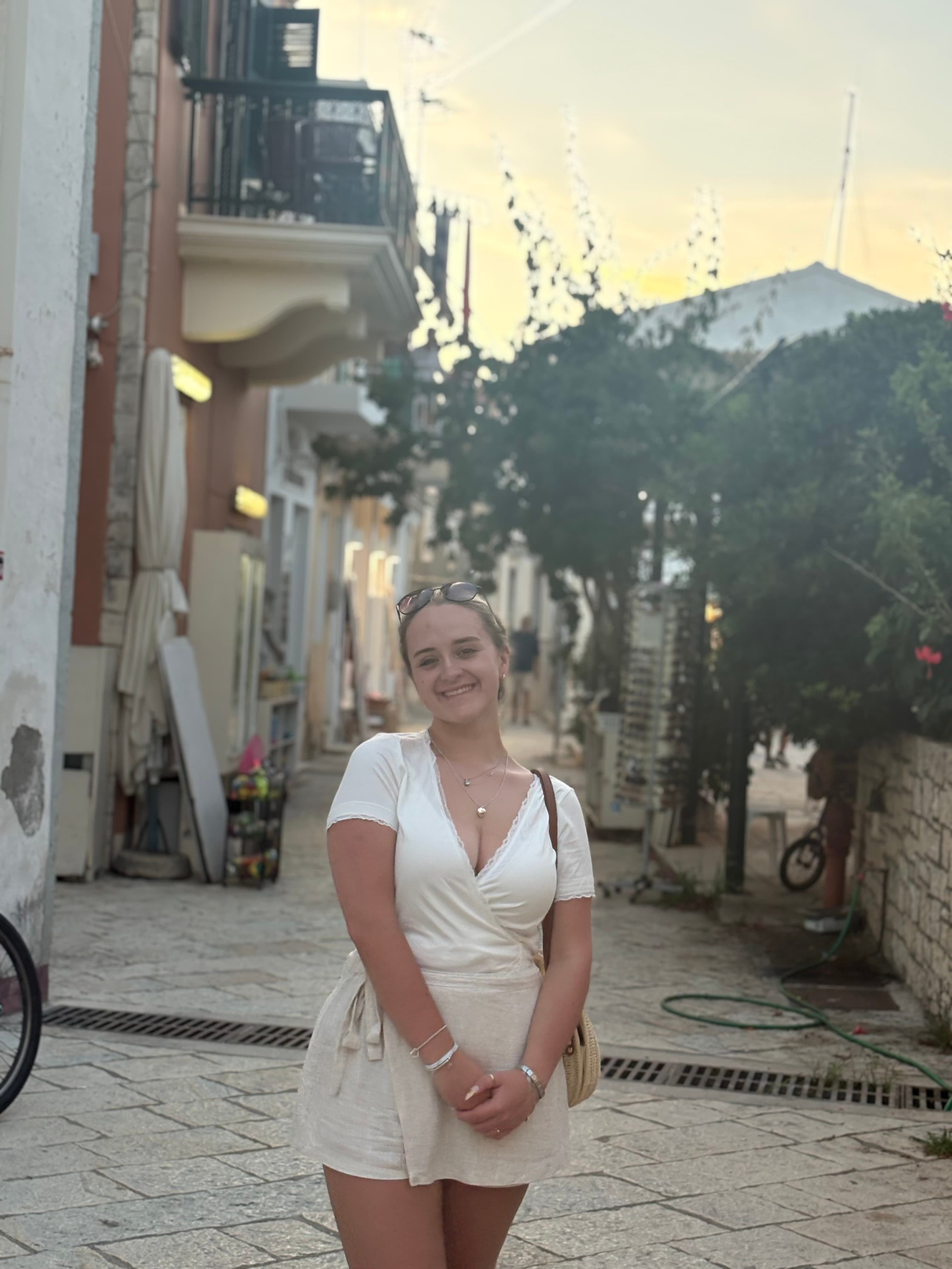 Gabriella Aboud smiling on a street at dusk